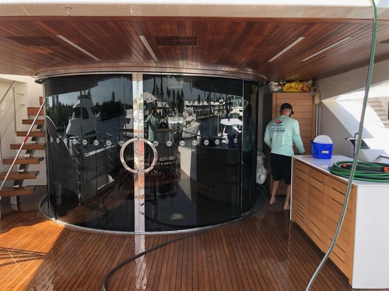 Swift Marine Yacht Management employee performing teak deck cleaning and restoration process